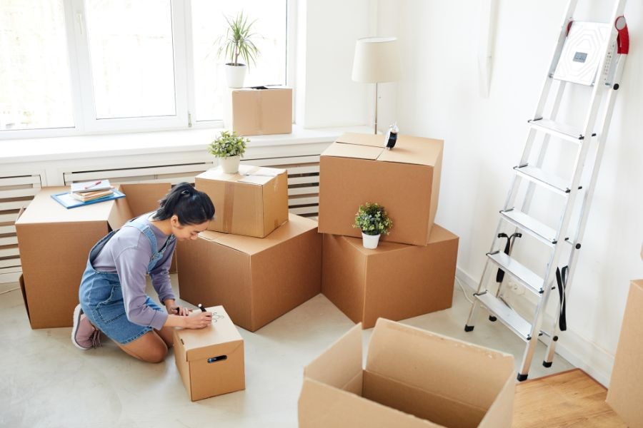 woman packing her belongings to store away